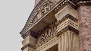Historic bank building facade with stone columns and “BANK” sign, illustrating SEO for banks and local SEO for banks.