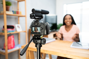 Professional content creator recording a finance video with DSLR camera and microphone, illustrating finfluencer marketing in Canada for wealth management firms and investment dealers.