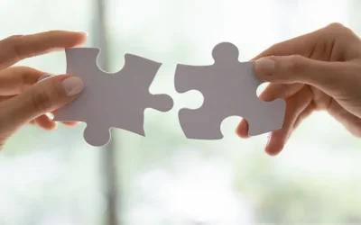PIC 2 – Lead Generation for Financial Advisors Blog Two hands connecting puzzle pieces symbolizing the strategic fit of digital marketing and client acquisition in lead generation for financial advisors.